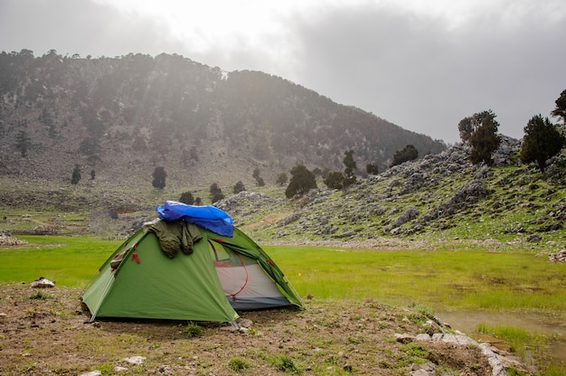 Small tent in front of the mountains