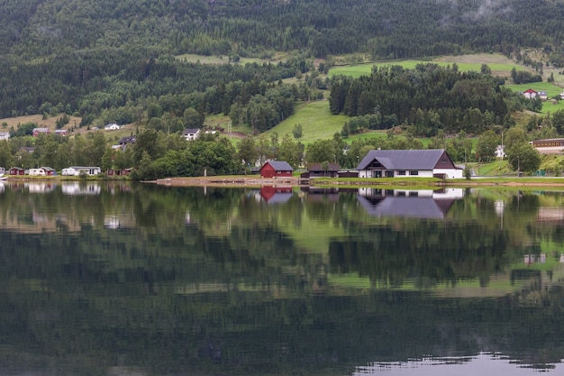 Small town in Norwegian fjord is beautifully reflected in the water