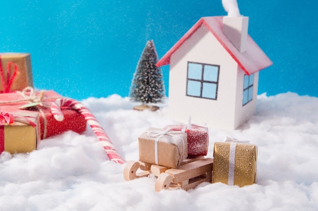 Small toy house and wooden sled