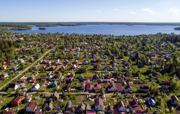 A small village on the shore of the lake Lots of country houses Karelia View from above