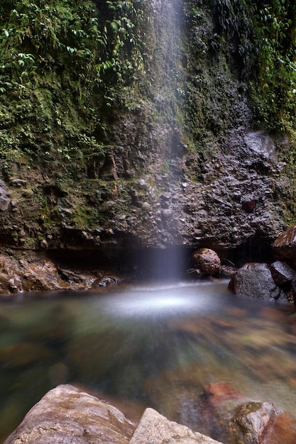 Small waterfall around many natural river rocks