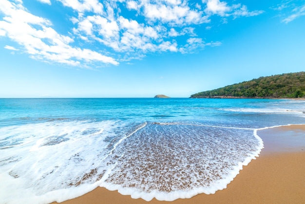 Small wave in La Perle beach on a cloudy day Guadeloupe Caribbean sea