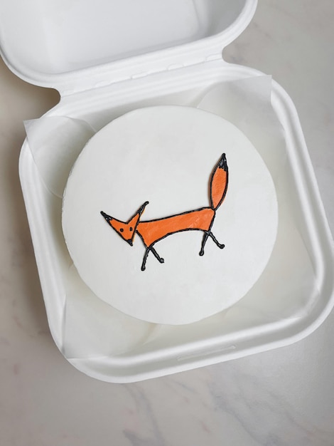 Small white bento cake with a drawn fox as a gift for the holiday mock up for design