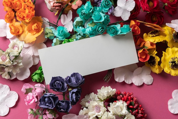 A small white greeting card between the flowers simple holidays template mockup