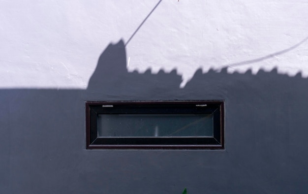 small window on the wall of a minimalist industrial house