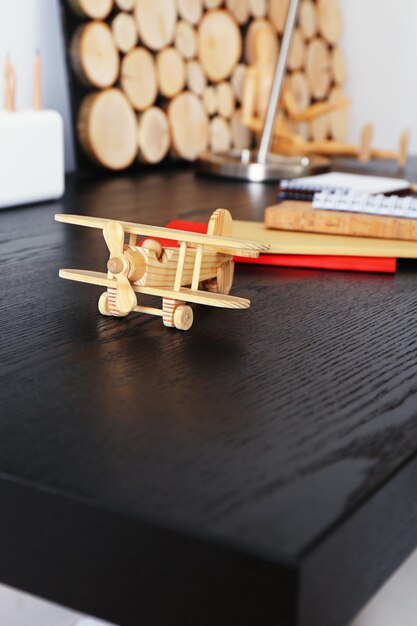 Small wooden model of airplane on desktop closeup