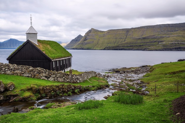 Small wooden village church on the sea shore in Faroe Islands Denmark