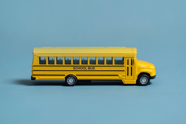 A small yellow schooldbus toy isolated concept of child education