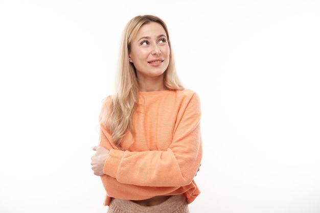 Photo smart blonde girl in casual grimacing and biting her lips thinks doubts makes decision isolated on white studio background