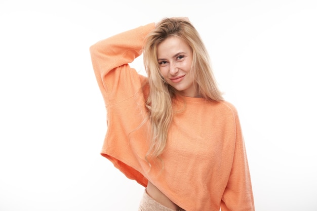 Smart blonde girl in casual holding her head thinks doubts makes decision isolated on white studio background