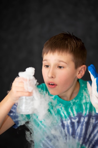 Smart boy scientist screaming in surprise while doing chemical experiments in the laboratory