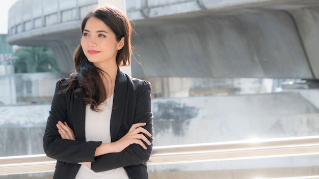 smart business girl thinking and city background