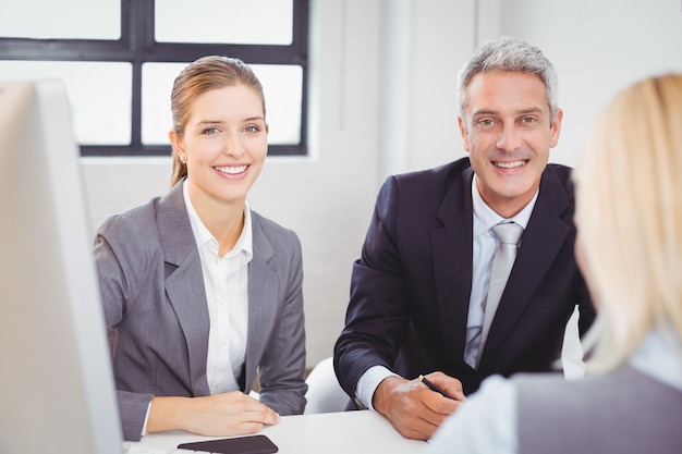 Smart business people sitting at desk in office