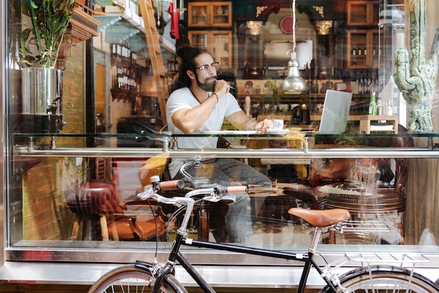 Smart creative man thinking while searching for new ideas