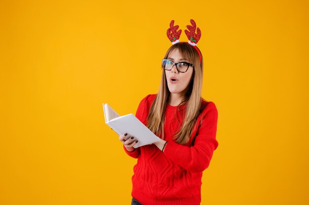 Smart funny girl holding book with copy space cover reading with glasses