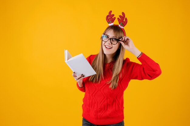 Smart funny girl holding book with copy space cover reading with glasses