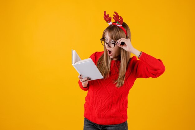 Smart funny girl holding book with copy space cover reading with glasses