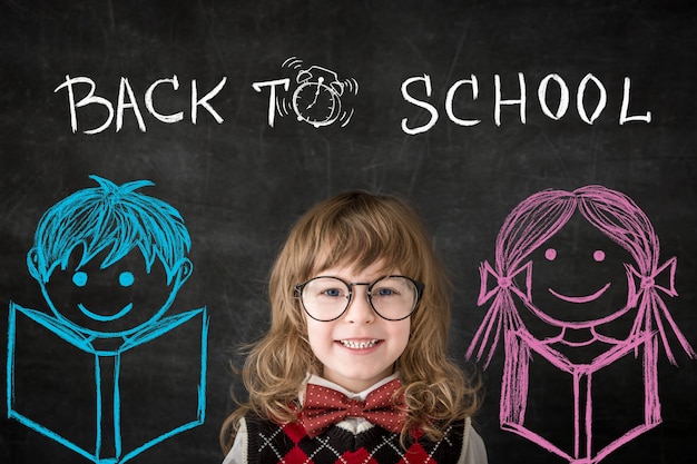 Smart kids in class. Happy children against blackboard. Education concept