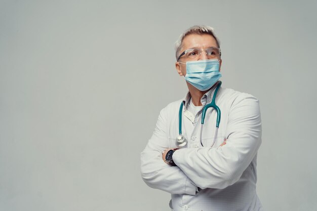 A smart man in a doctor's suit with a mask Doctor Age is a smart medic in glasses and a white coat