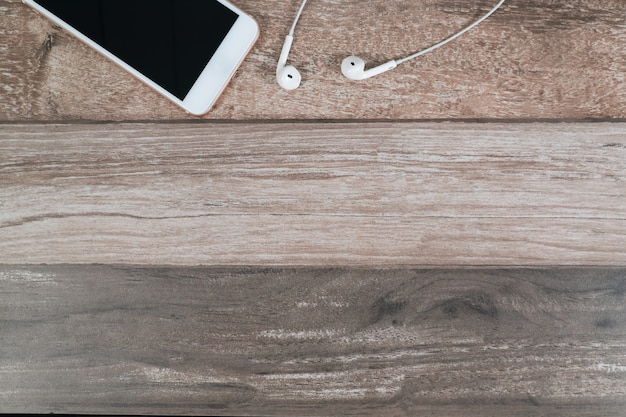 Smart phone and earphone on office desk