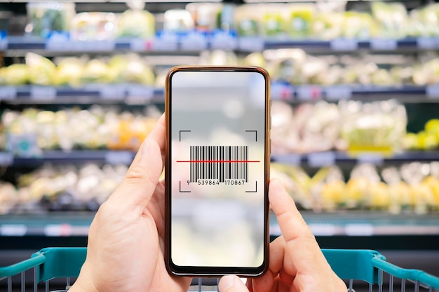 Smart retail conceptFemale hands using barcode scan for information of product in supermarket