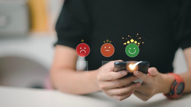 Smart woman use smartphone choosing green happy smile face icon feedback rating and positive customer review experience satisfaction survey mental health assessment world mental health day concept