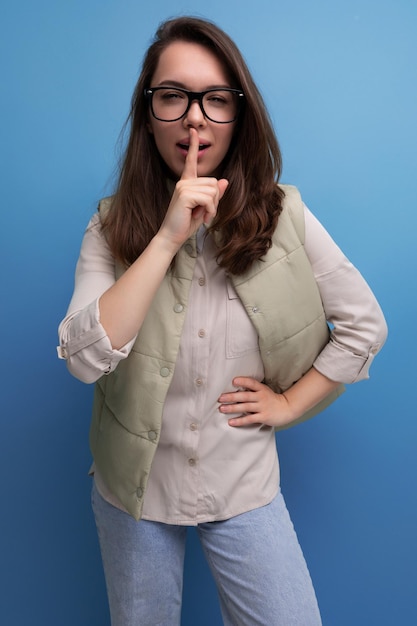 Smart young brunette woman in casual look and glasses tells interesting news