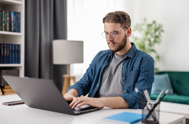 Smart young man sitting at desk