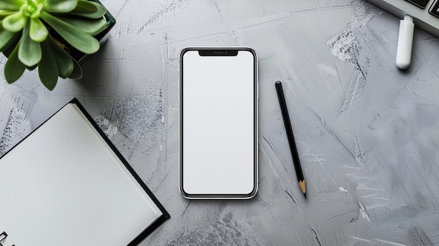 Smartphone mockup on desk with plant and stationery Minimalist workplase top view