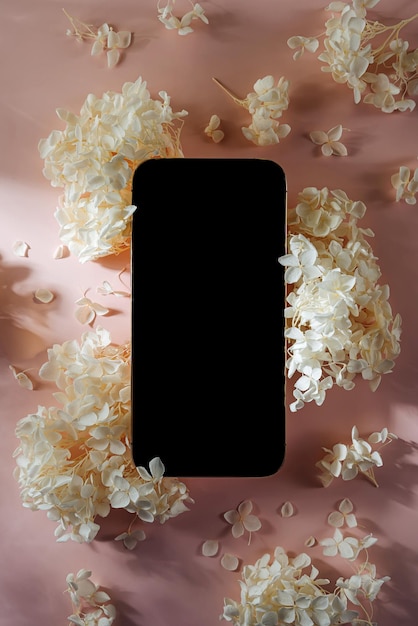 Smartphone mockup with white flowers on pink background Device screen mock up on stylish background for presentation or appl design