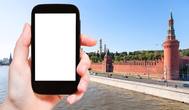 Smartphone and red walls of Moscow Kremlin