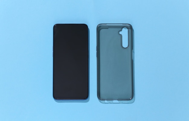 Smartphone and silicone protective cover on blue background. 