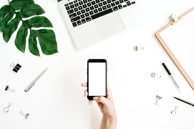 Smartphone with blank screen in female hand