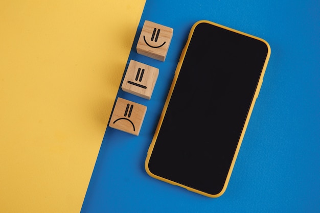 Smartphone with three mini boxes on blue and yellow background