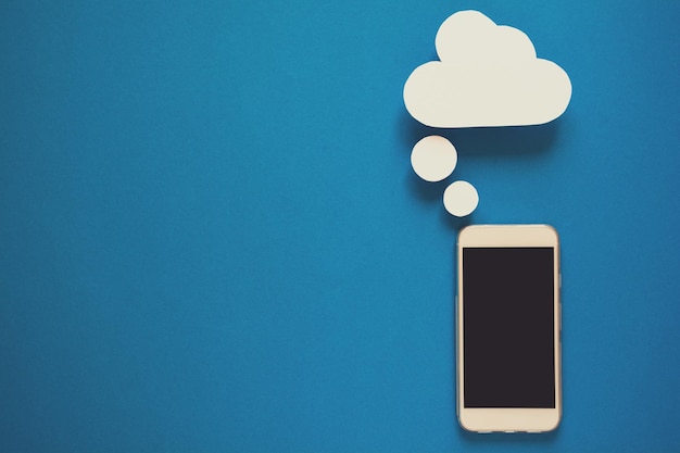 Smartphones with paper speech bubbles on blue background Communication concept