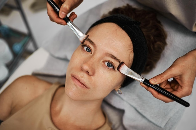 A smear of cream on the face of a young woman brush massage high quality photo