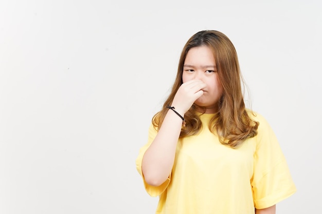 Smelling something stinky and disgusting of Beautiful Asian Woman wearing yellow TShirt