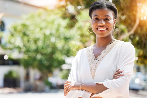 Smile business and arms crossed with portrait of black woman in city for pride confidence or entrepreneur Creative manager and urban with face of person in outdoors for expert mission and career