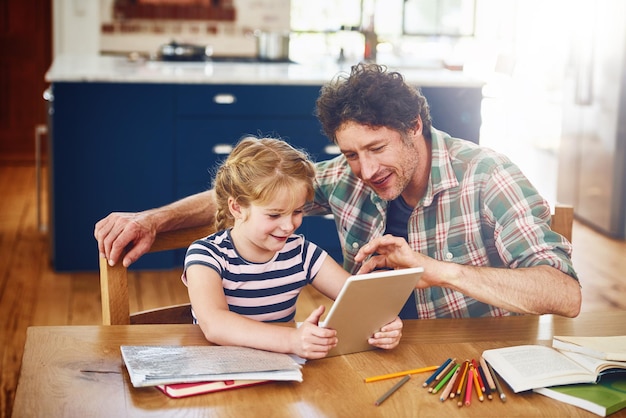 Photo smile dad and girl with tablet for homework in home on table on elearning for child development knowledge and growth parent kid and support with help for learning on internet for educational game