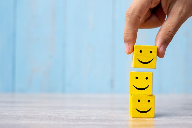 Smile face on yellow wood cube