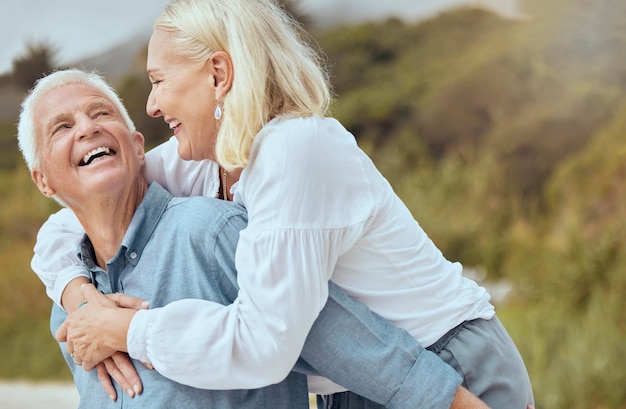 Photo smile senior and couple with piggyback outdoor for fun or goofy activity in nature love and playful with romance man woman and laugh together with back hug laughing and silly on retirement trip