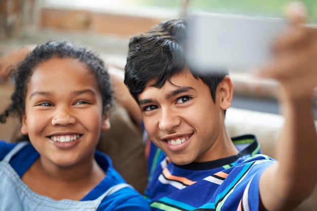 Smile sis Cropped shot of a little brother and sister taking a selfie