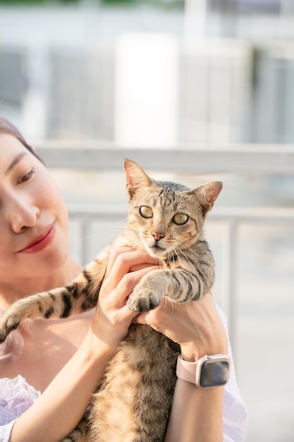 Smile woman holding grey cat