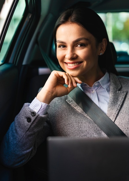 Smiley businesswoman posing in the car