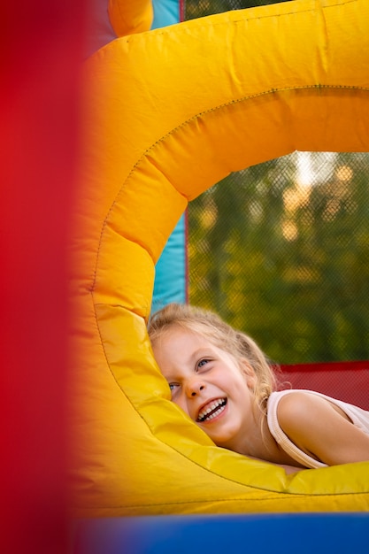 Smiley girl in bounce house medium shot