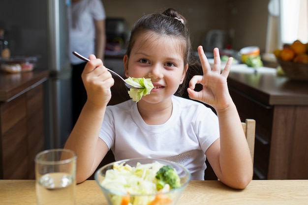 Smiley girl having a heathy meal