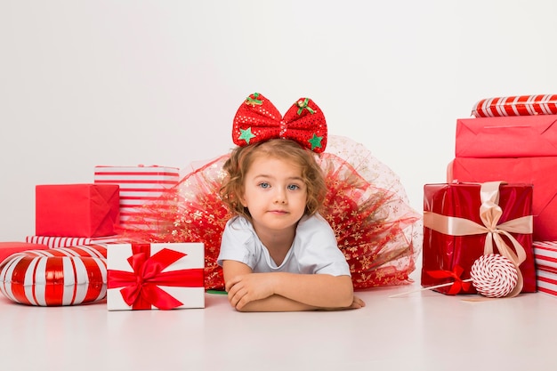 Smiley little child surrounded by christmas elements