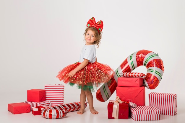 Smiley little kid surrounded by christmas elements