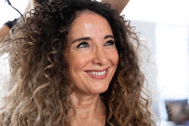 Smiley mature beauty woman in a hairdresser salon