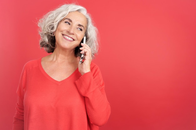 Smiley mature woman talking to the mobile